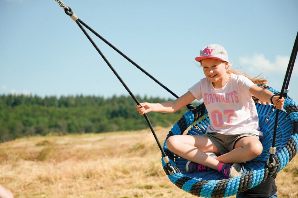 Girl swinging on NetPlay swing