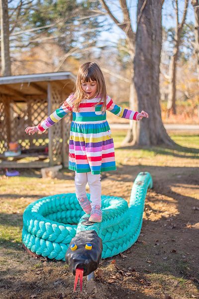 Girl balancing on Green Mamba Climber