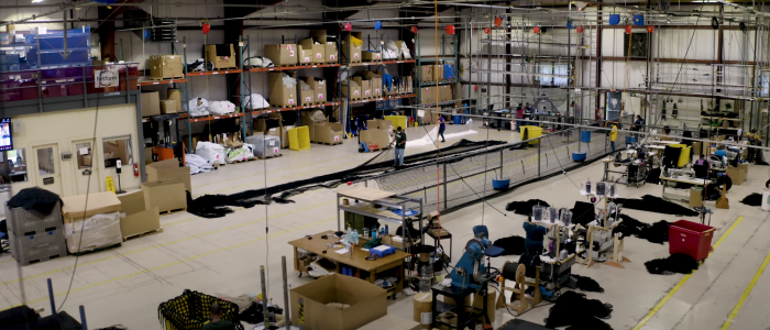 An overhead shot of InCord production facilities showing many machines, rope, nets and workers.
