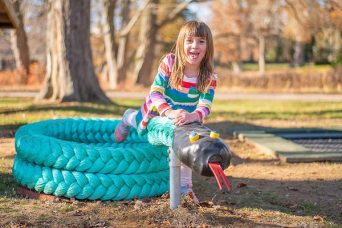 Girl playing on the Green Mamba Climber